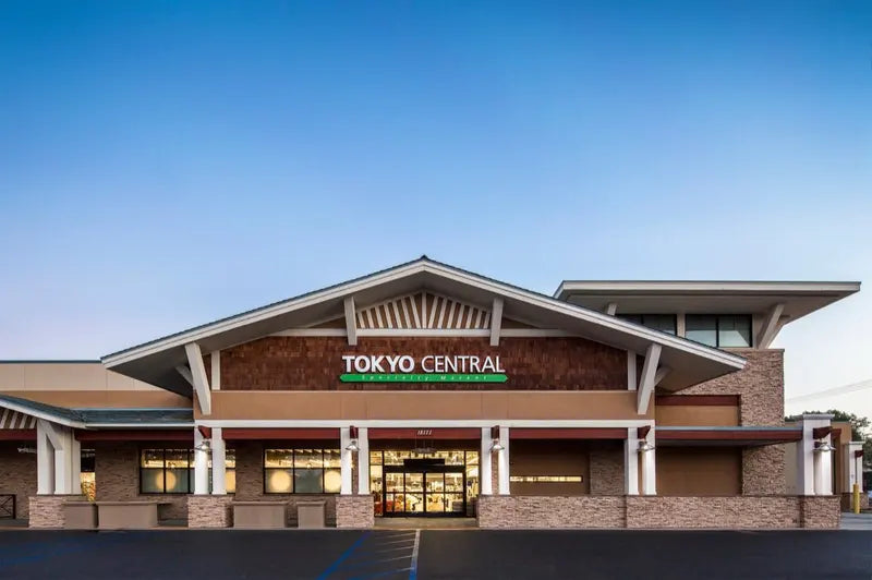 Tokyo Central store exterior at dusk with green illuminated signage
